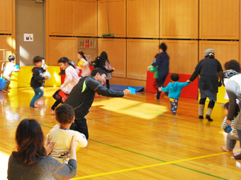 体育室でボール遊びをする親子